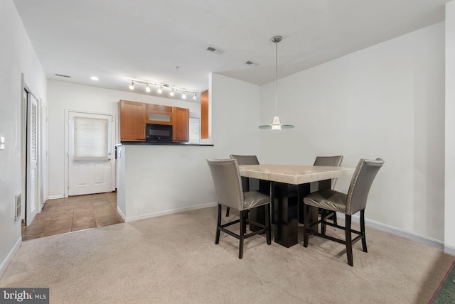 dining area with light carpet