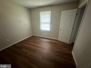 spare room featuring dark hardwood / wood-style floors