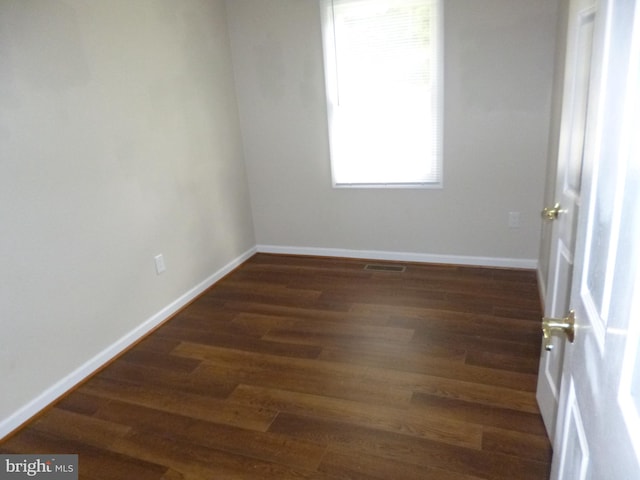 empty room featuring dark hardwood / wood-style flooring