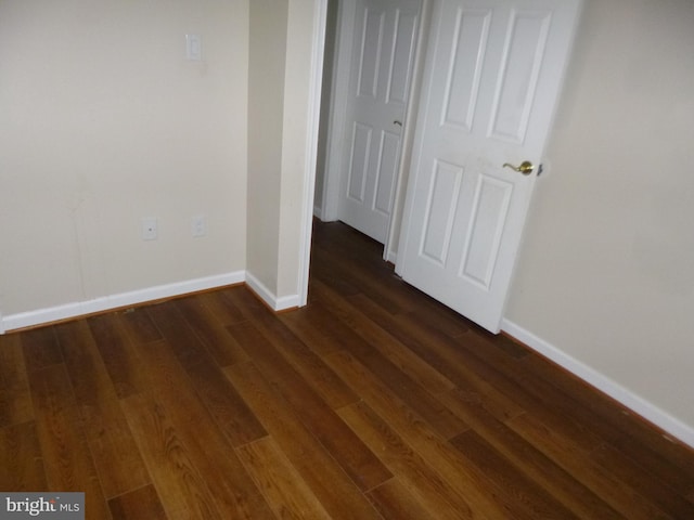 unfurnished bedroom with dark hardwood / wood-style flooring