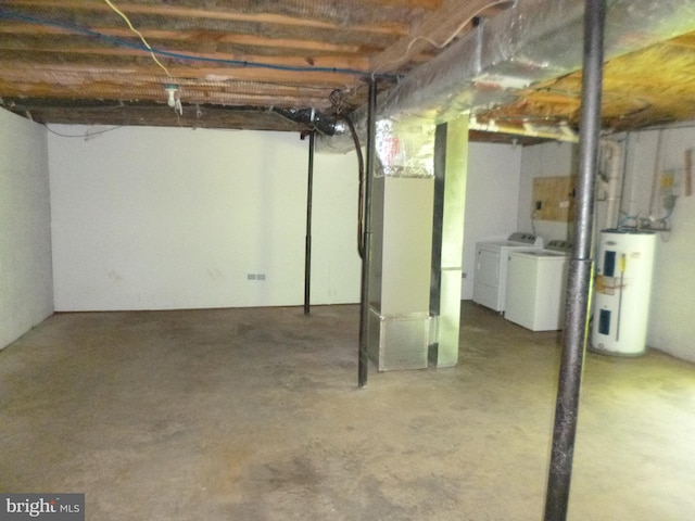 basement featuring washing machine and dryer and water heater