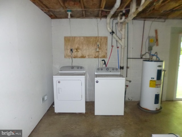 laundry area with washer and dryer and water heater