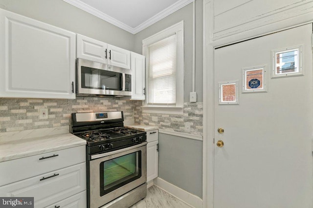 kitchen featuring stainless steel appliances, tasteful backsplash, light stone counters, crown molding, and white cabinets