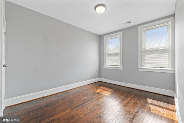 empty room with dark wood-type flooring