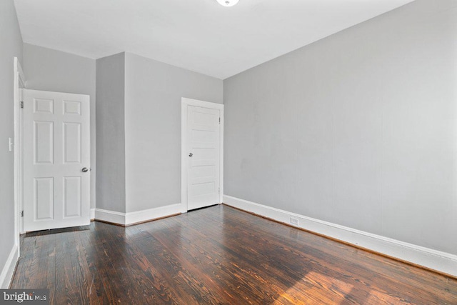 empty room with dark hardwood / wood-style floors