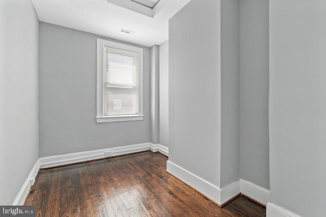 spare room with dark hardwood / wood-style floors