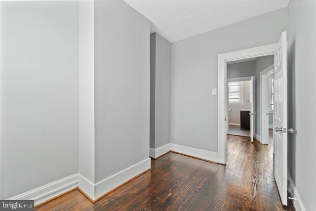 unfurnished room featuring dark wood-type flooring