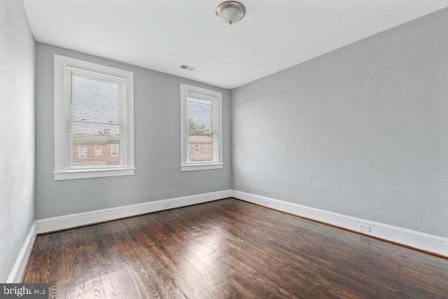 unfurnished room featuring dark wood-type flooring