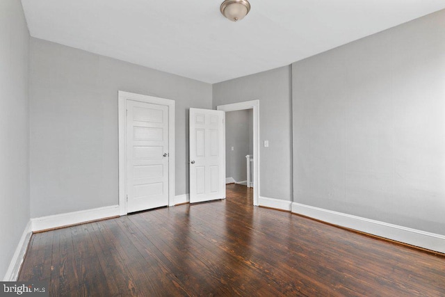 unfurnished bedroom featuring dark wood-type flooring