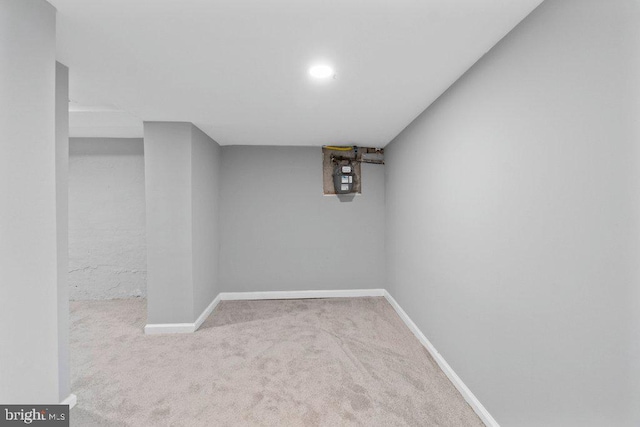 basement featuring light colored carpet