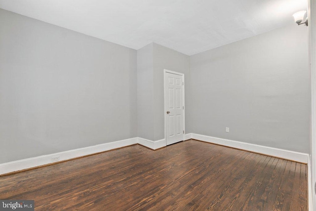 empty room featuring dark hardwood / wood-style flooring