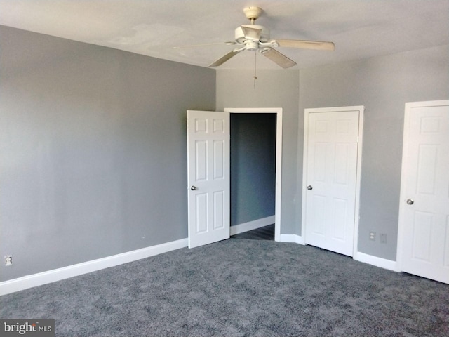 unfurnished bedroom featuring dark carpet and ceiling fan