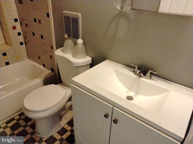 full bathroom with vanity, tiled shower / bath combo, and toilet