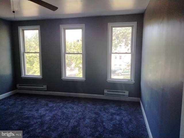 empty room with ceiling fan, baseboard heating, and dark colored carpet