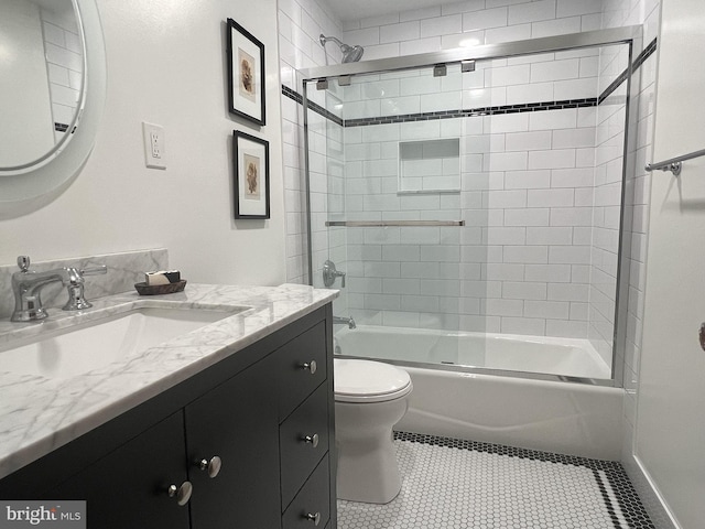 full bathroom featuring tile patterned flooring, vanity, toilet, and enclosed tub / shower combo