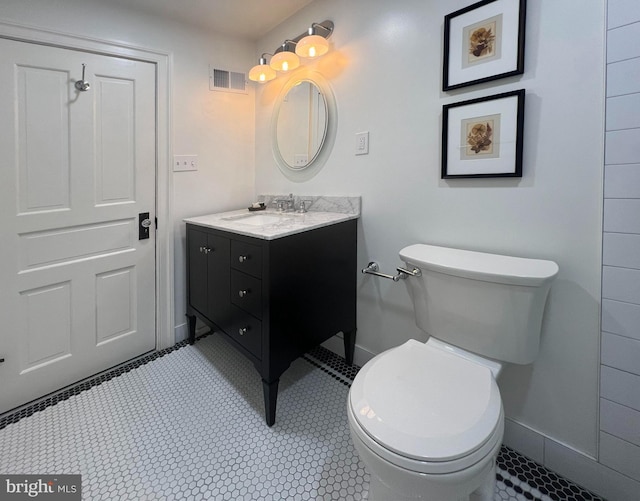 bathroom with tile patterned floors, vanity, and toilet