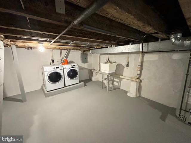 basement with independent washer and dryer, sink, and electric panel