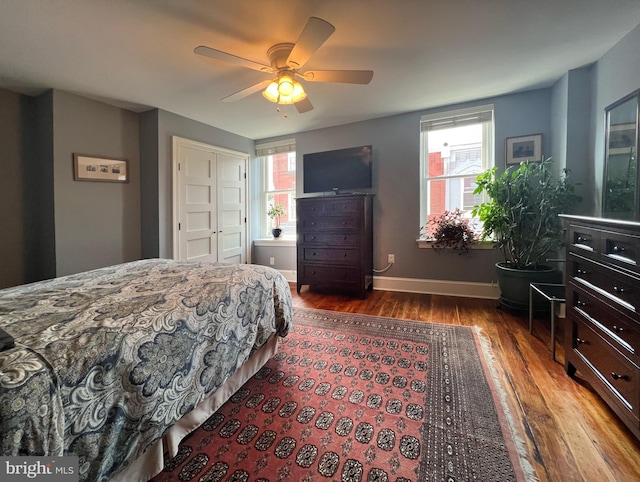 bedroom with a closet, ceiling fan, and hardwood / wood-style flooring