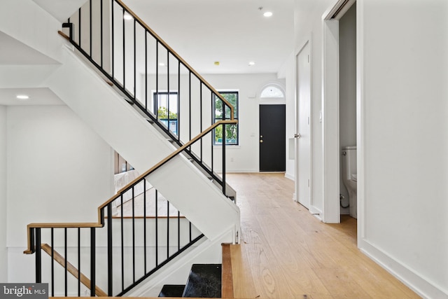 staircase with hardwood / wood-style floors