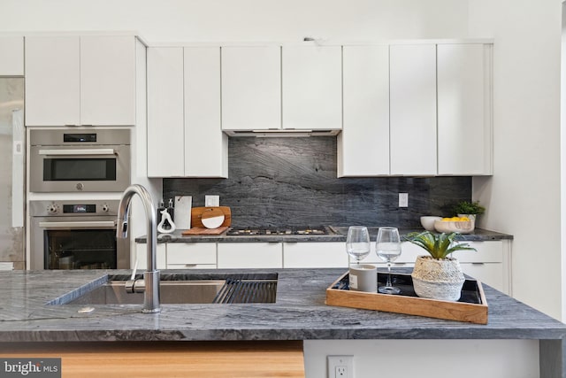 kitchen featuring black gas cooktop and white cabinets