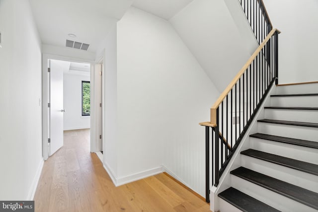 stairway featuring hardwood / wood-style flooring