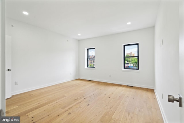 spare room featuring light hardwood / wood-style floors