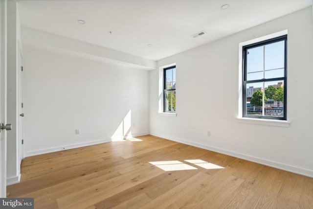 spare room featuring light wood-type flooring