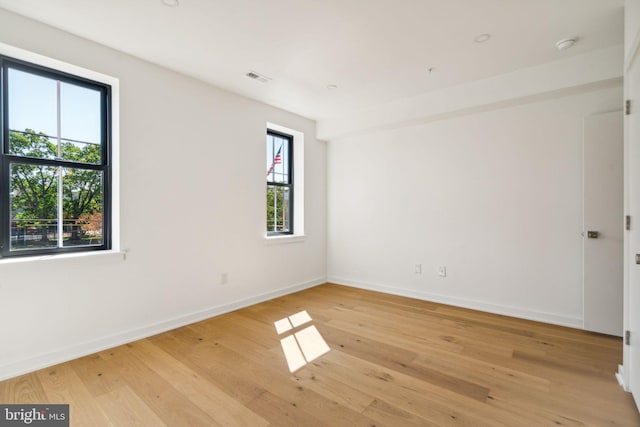 spare room with light hardwood / wood-style flooring