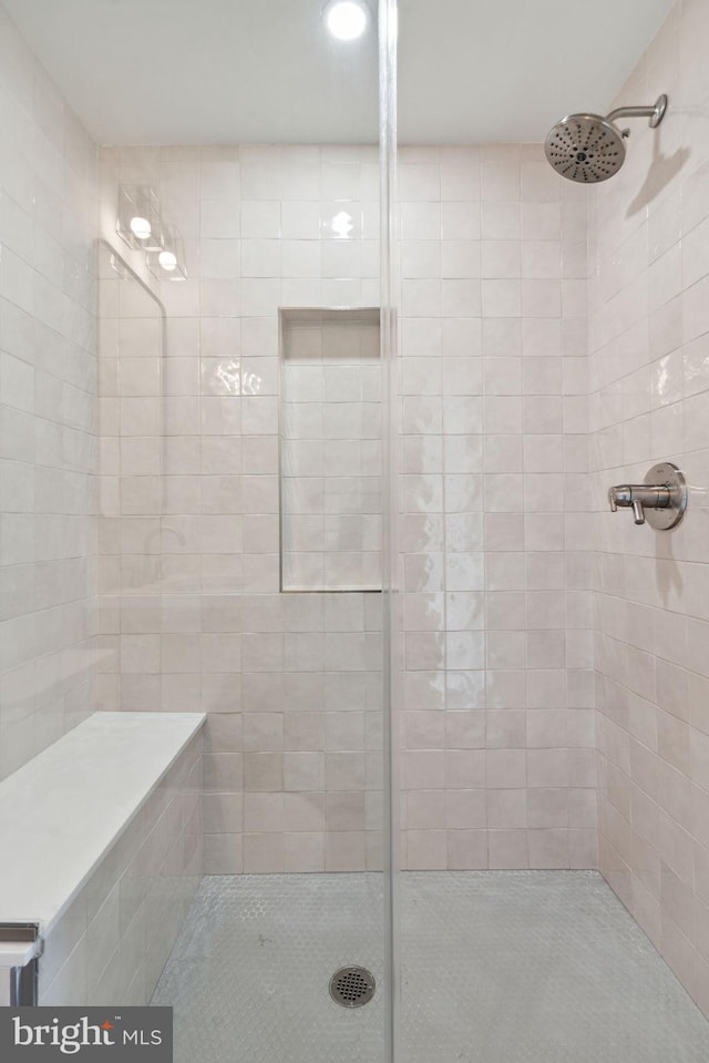 bathroom with tiled shower