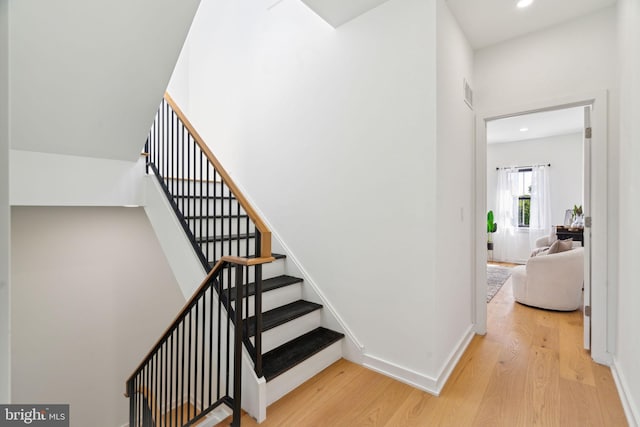 stairway featuring hardwood / wood-style flooring