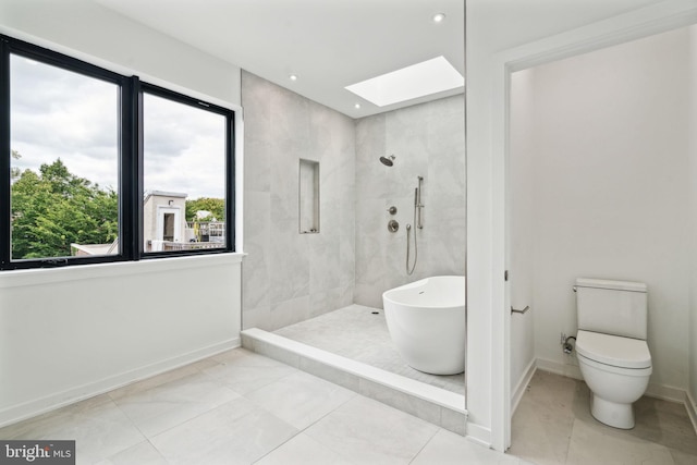 bathroom with a skylight, toilet, a wealth of natural light, and independent shower and bath