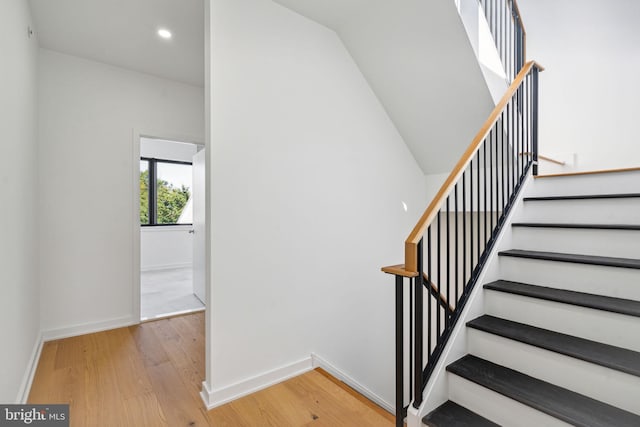 staircase with hardwood / wood-style floors