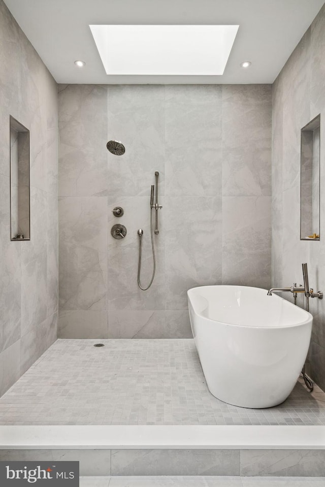 bathroom featuring tile walls, independent shower and bath, and a skylight