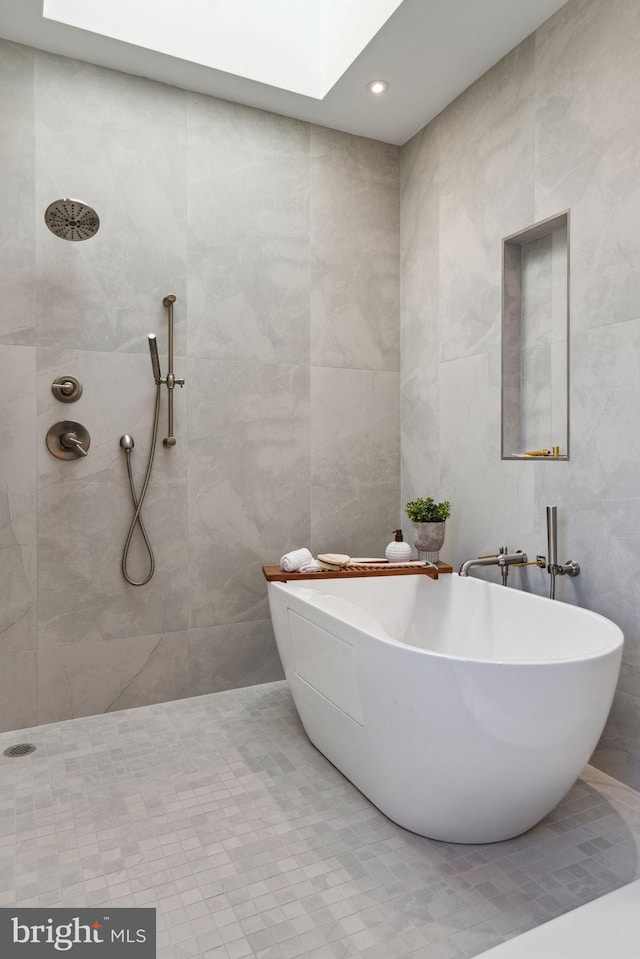 bathroom featuring tile walls, independent shower and bath, and tile patterned flooring