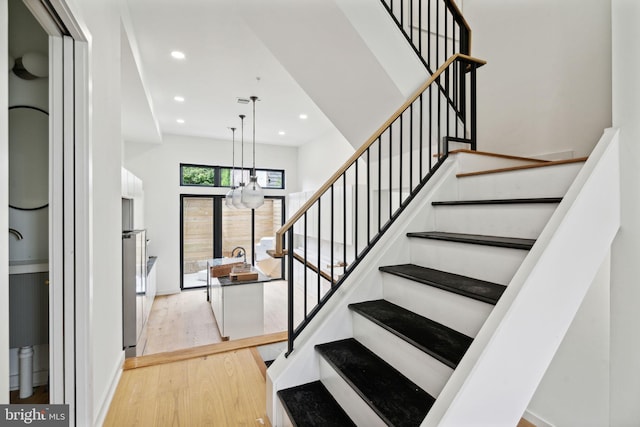 staircase with hardwood / wood-style flooring