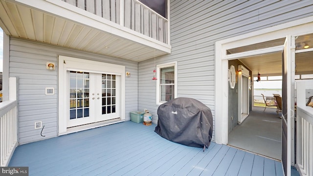 wooden terrace featuring area for grilling and french doors