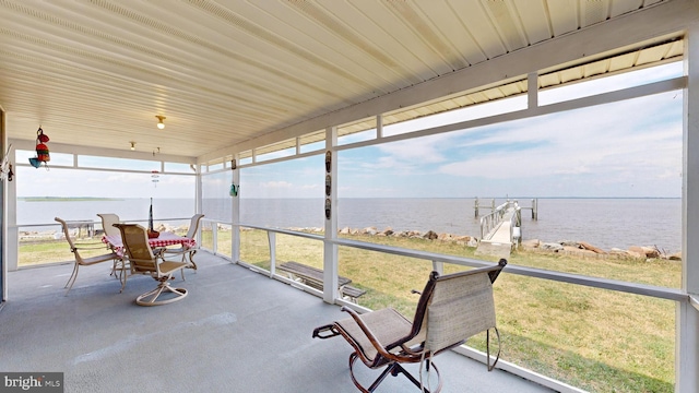 unfurnished sunroom with plenty of natural light and a water view