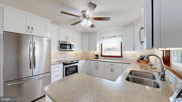 kitchen with white cabinets, sink, and appliances with stainless steel finishes