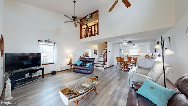 living room with hardwood / wood-style floors and a high ceiling