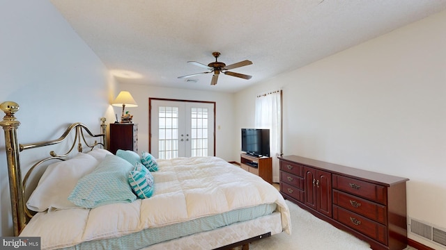 carpeted bedroom featuring access to outside, ceiling fan, french doors, and a textured ceiling