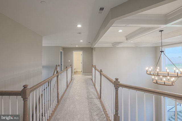 hallway featuring an inviting chandelier, crown molding, coffered ceiling, and beamed ceiling