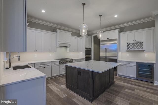 kitchen featuring beverage cooler, a center island, white cabinetry, stainless steel appliances, and sink