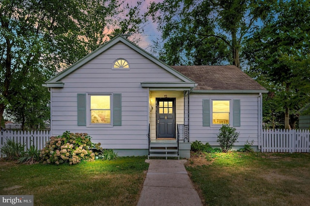 bungalow-style house featuring a yard