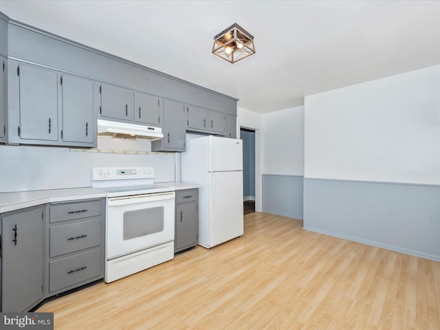 kitchen featuring light hardwood / wood-style floors and white appliances