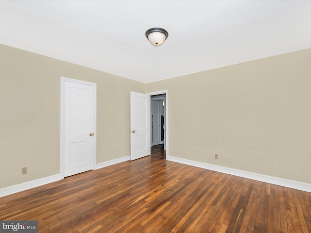 unfurnished bedroom with dark hardwood / wood-style floors