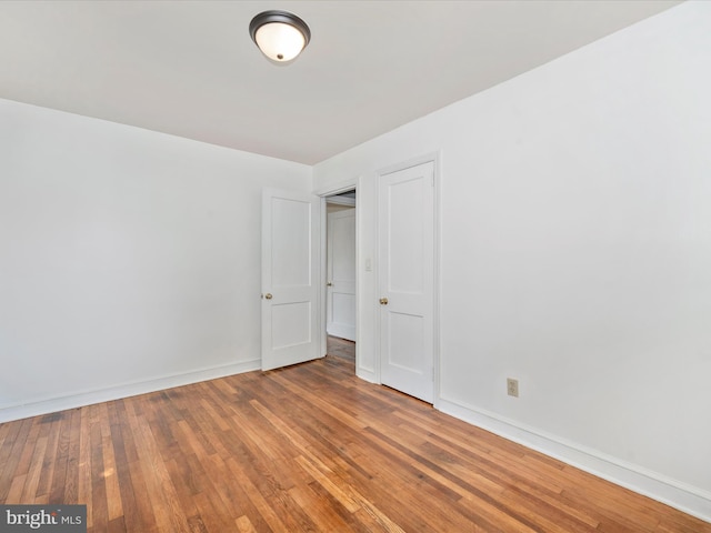 unfurnished room featuring hardwood / wood-style flooring