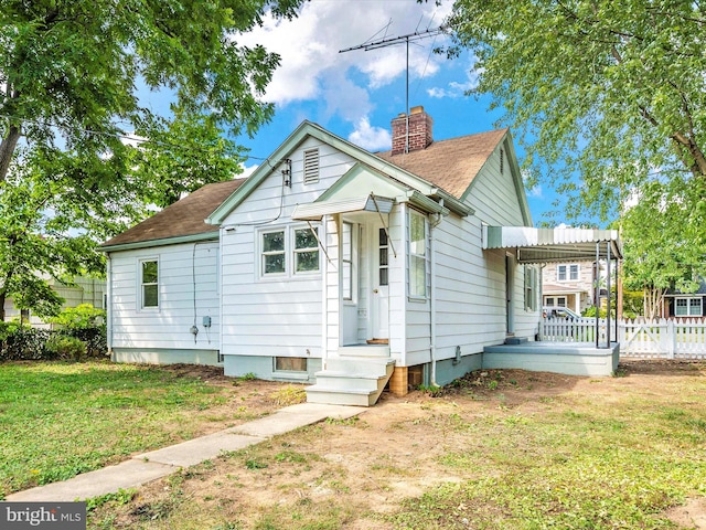 bungalow-style house with a front lawn