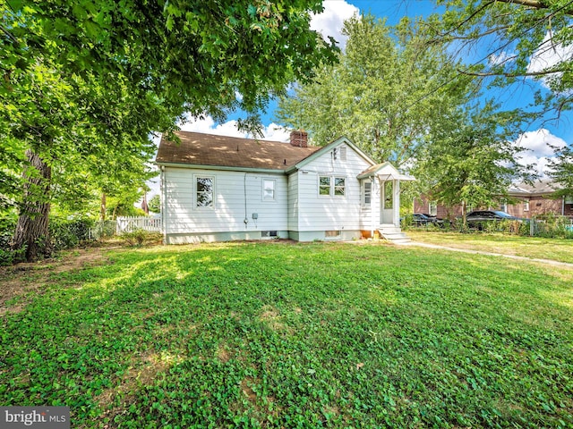 rear view of house with a lawn