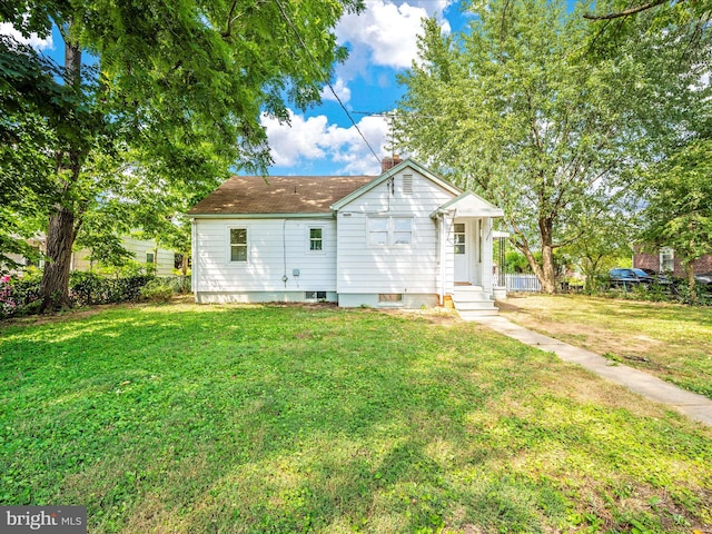 back of house with a yard