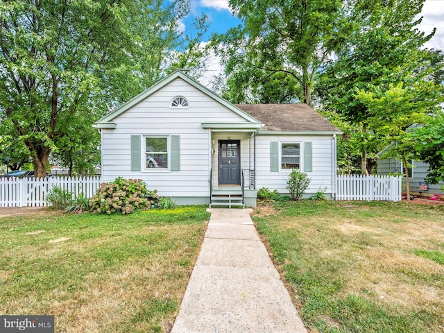 bungalow-style home featuring a front yard